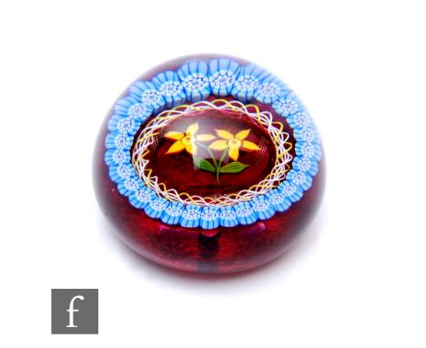 A John Deacons and William Manson for Strathearn glass paperweight of domed form, internally decorated with two stylised ambe