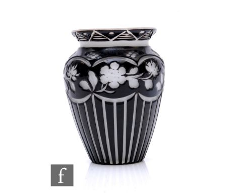 A late 19th Century Stourbridge glass vase by Stevens and Williams, the body cased in black over clear crystal over opal and 