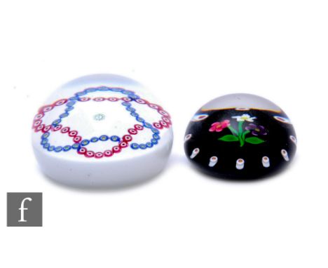 A contemporary William Manson glass paperweight of domed form, internally decorated with a central complex signature cane and