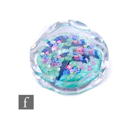 A later 20th Century Whitefriars glass paperweight, internally decorated with multicoloured millefiori canes separated by whi