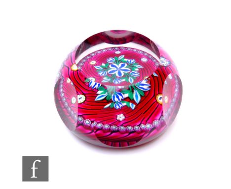 A later 20th Century Perthshire glass paperweight of domed form with facet cut top and printie cut sides, internally decorate
