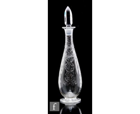 A Webb Corbett glass decanter of footed slender tapering form, engraved with vertical panels of stylised flowers, with facete