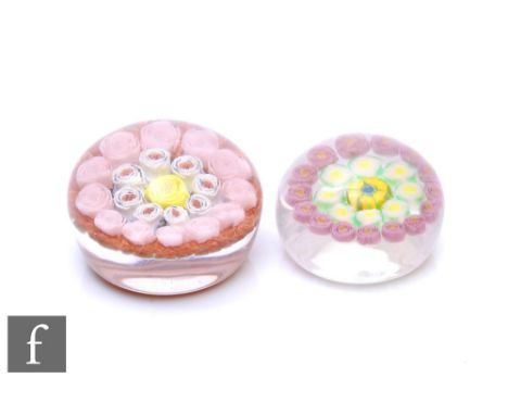 A contemporary Jim Hart glass paperweight, of domed form, internally decorated with a central yellow rose surrounded by conce