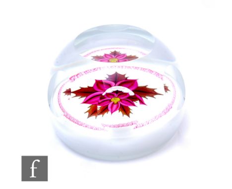 A later 20th Century William Manson for Caithness glass paperweight, in the Winter Flower pattern, internally decorated with 