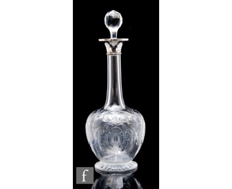 An early 20th Century hallmarked silver and glass decanter of footed globe and shaft form, decorated with oval cartouches con