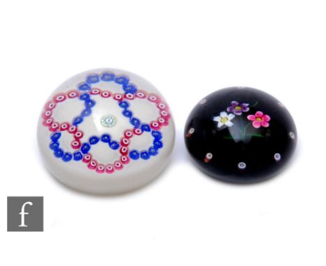 A contemporary William Manson glass paperweight of domed form, internally decorated with a central complex signature cane and
