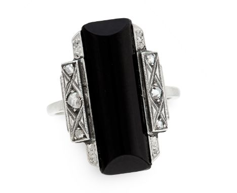 AN ART DECO ONYX AND DIAMOND DRESS RING set with an elongated rectangular onyx cabochon accented by rose cut diamonds, unmark