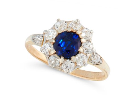 A SAPPHIRE AND DIAMOND DRESS RING in high carat yellow gold, set with a cushion cut blue sapphire of 0.94 carats within a bor