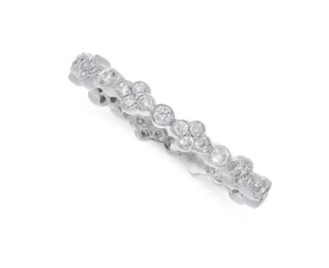 A DIAMOND BAND RING set with alternating quatrefoil and circular diamond set motifs, unmarked, size L / 5.5, 1.63g.