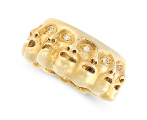 A VINTAGE DIAMOND DRESS RING in high carat yellow gold, formed of a row of theatrical mask faces set with round cut diamonds,