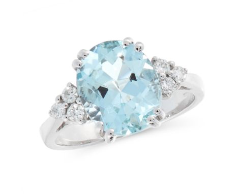 AN AQUAMARINE AND DIAMOND DRESS RING in 18ct white gold, set with an oval cut aquamarine, each shoulder is set with a trio of