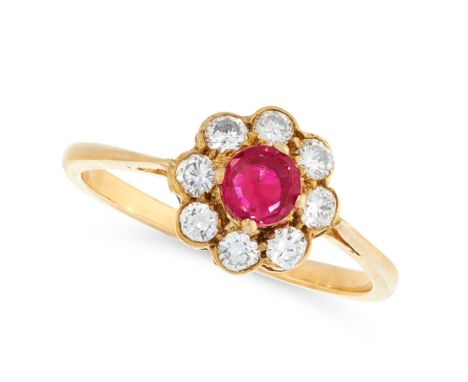 A RUBY AND DIAMOND DRESS RING in yellow gold, set with a round cut ruby within a border of round cut diamonds, unmarked, size