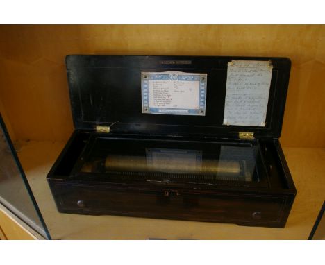 A 19th Century Swiss music box by Bremond within a rosewood and inlaid case, playing twelve airs 58cm length 