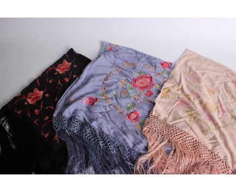 A black silk fringed shawl embroidered with flowers in shades of pink and red; a blue silk fringed shawl embroidered with flo