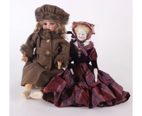 A Simon & Halbig for Kammer & Reinhardt bisque socket-head doll, with a pale brown wig, sleeping blue glass eyes and an open 