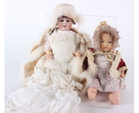 Early 20th Century bisque head doll, with cropped brown wig, sleeping blue glass eyes, an open mouth with two upper teeth, co
