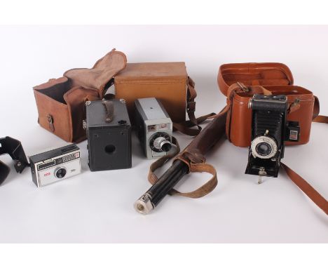 A box camera, two other cameras, a Zeiss tripod and assorted lenses