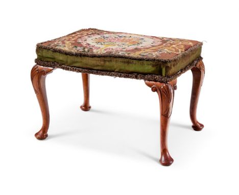 A WALNUT AND TAPESTRY UPHOLSTERED STOOL IN THE GEORGE II STYLE  20TH CENTURY  With shell carved knees and pad feet  46cm high