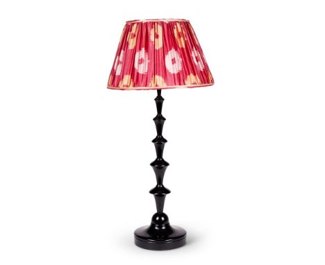 A BLACK CAST RESIN 'BEANPOLE' TABLE LAMP  BY MARIANNA KENNEDY, MODERN With a silk Ikat pattern pleated shade  64cm incl. fitt