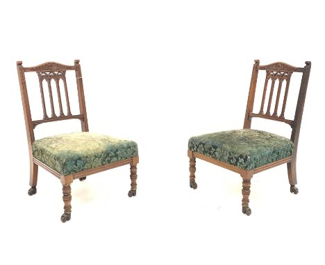 Pair late Victorian walnut bedroom chairs, shaped cresting rail carved with flower heads, upholstered sprung seats, each supp