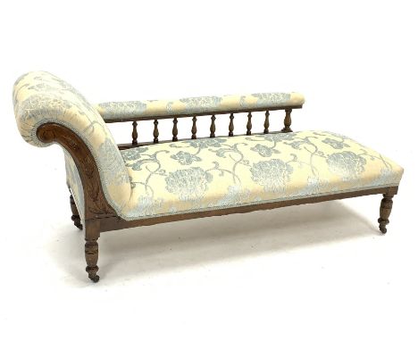 Edwardian beech framed chaise lounge, gallery back, turned supports with brass and ceramic castors, upholstered in raised flo