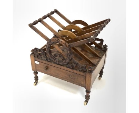  Victorian walnut three division Canterbury, with floral and ribbon carved decoration to each end, raised on turned supports 