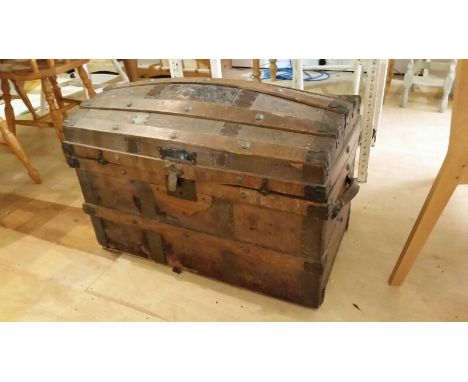 Domed top trunk with decorative leather inserts. Some attention and restoration required.  Measures approx:  79cm wide, 45cm 