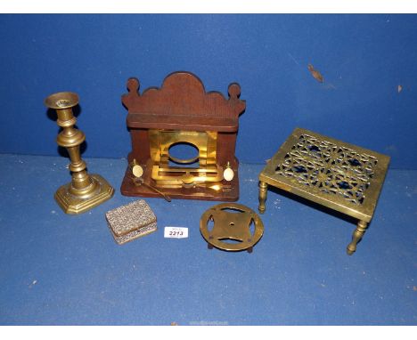 A small quantity of brass including candlestick with pusher, miniature apprentice piece wooden fireplace with small brass coa