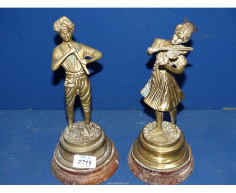 A pair of brass figures of a young couple playing the fiddle and the recorder, 10 1/2" tall including plinth.