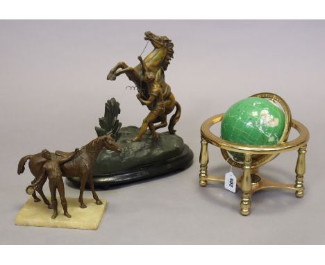 A small geological specimen globe, 24cm diameter; a Spelter Marley horse ornament, 29cm high; &amp; a spelter horse &amp; rid