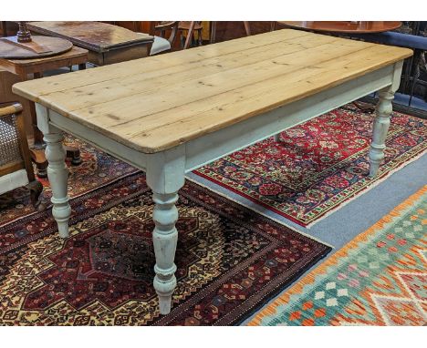 A pine farmhouse table with four-board scrub-top on light-blue painted turned supports, 195cm long x 88cm wide x 76.5cm high.