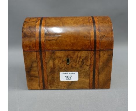 Walnut caddy, the domed top opening to reveal two lead lined divisions, with original covers, 18 x 15cm 