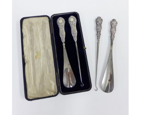 Edwardian silver handled button hook and shoe horn set, Birmingham 1905,in fitted case together with another set with Birming