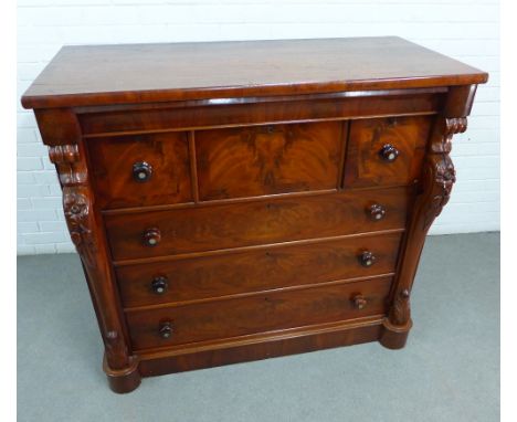 Victorian flame mahogany Scotch chest with three short drawers and three long drawers, flanked by scrolling uprights, the bun