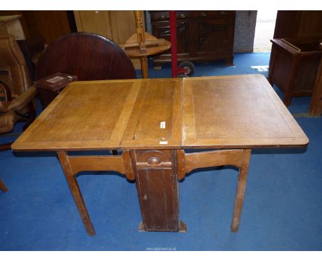 A light oak dropleaf table, 60'' open (30'' closed) x 36'' wide x 30'' high.