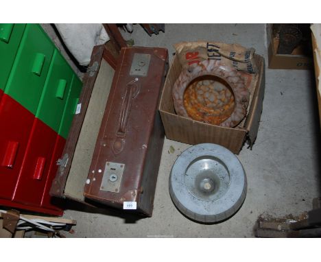 A case and two glass lamp shades.