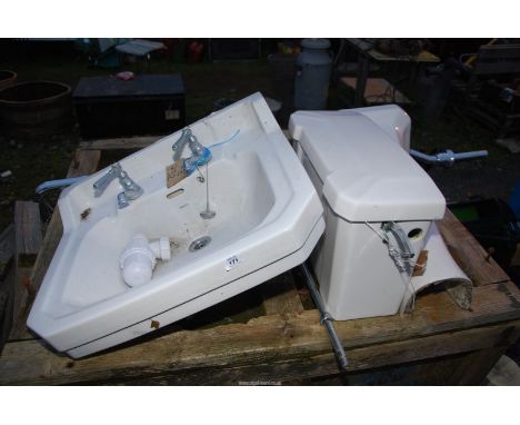 A Savoy hand basin with pedestal plus header tank and chrome feed pipe.