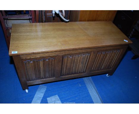 A light oak blanket box on castors, 45'' wide x 17 1/2'' deep x 21'' high.