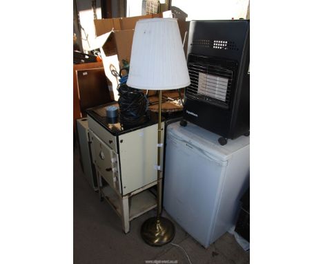 A brass standard lamp and shade.