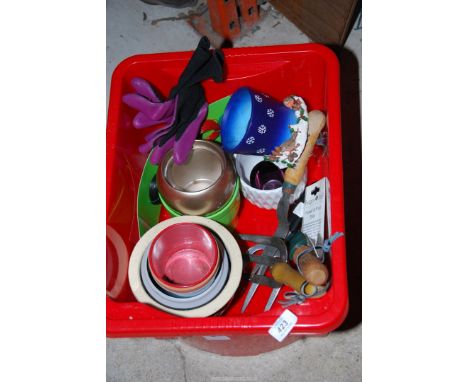 Garden gloves, hand tools, and a coloured plant pots.