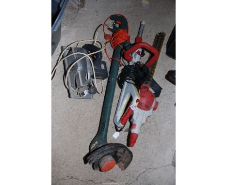A 'Black & Decker' strimmer, 110v rip saw, electric hedge trimmer and strimmer, not working.