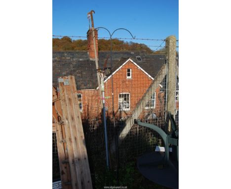 A pruning saw, long armed lopper and a bird feeder pole.