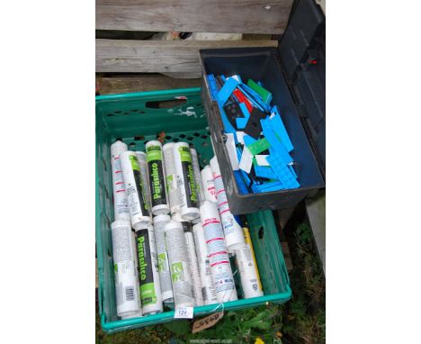 A tub of silicone adhesive and small plastic toolbox and contents.