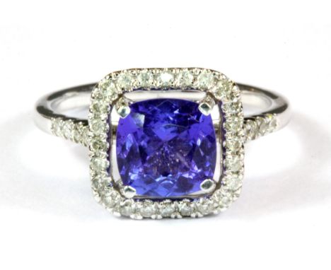 An 18ct white gold (Stamped 750) tanzanite and diamond set halo ring, 2.5ct tanzanite &amp; 0.35ct diamonds, (O).