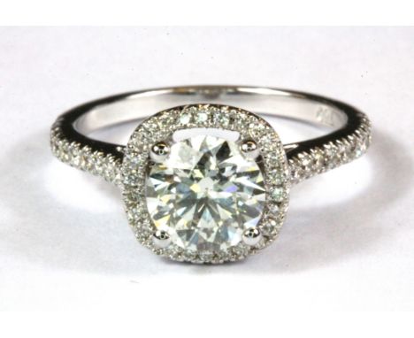An 18ct white gold (stamped 750) diamond set halo ring, approx. 1.35ct centre, (N).