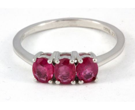 A 9ct white gold three ruby set ring, (P.5).