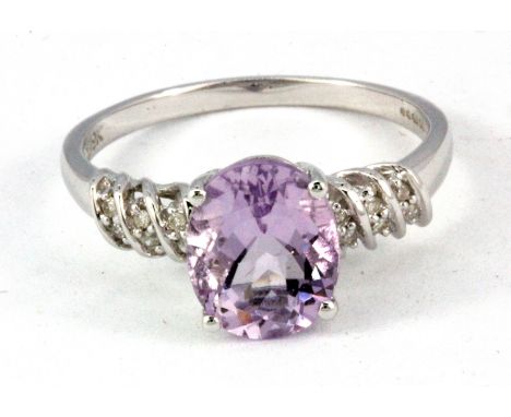 A 9ct white gold amethyst set ring with diamond set shoulders, (Q).