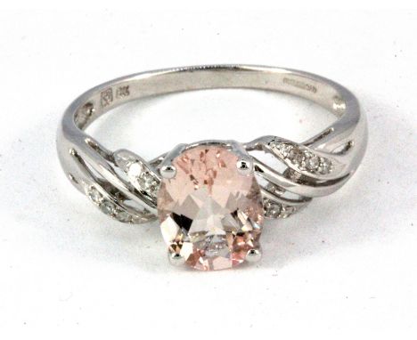 A 9ct white gold morganite set ring with diamond set shoulders, (T).