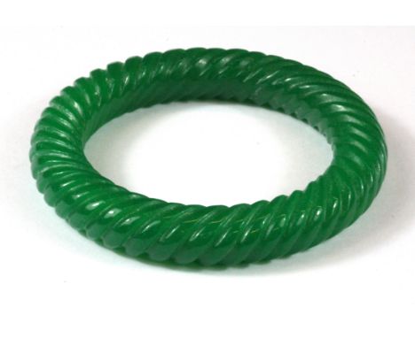 A Chinese carved jade bangle, Dia, 6cm.