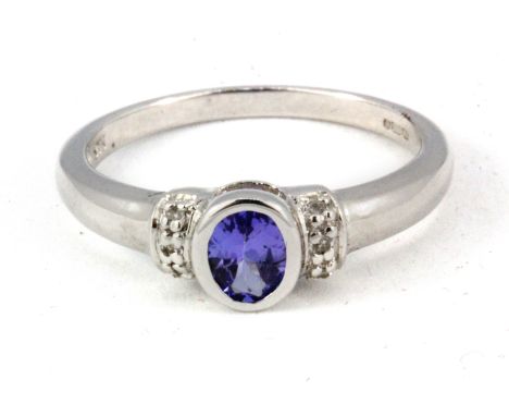 A 9ct white gold tanzanite and diamond set ring, (L.5).